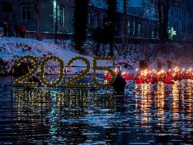 New Year's Torchlight Swim In The Bavarian River Lech In Fuessen