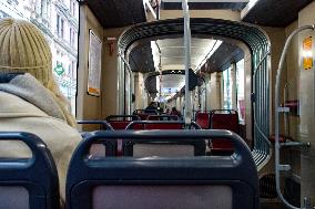 Woman Seated In A Tram