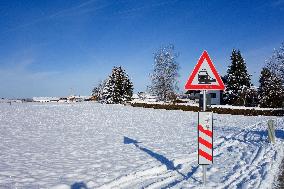 Railway Crossing Warning Sign In A Snowy Landscape