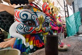 Artisans finish floats for Carnival parade of Blacks and Whites Carnival