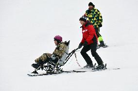 Ukrainian war veterans visit adaptive skiing training session in Kyiv