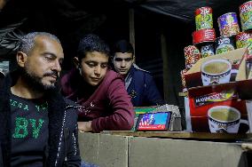 Displaced Residents Follow the News - Gaza