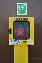 Wall-Mounted Defibrillator In An Urban Street