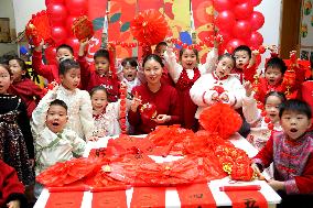 Children Learning Folk Customs to Welcome Chinese Lunar New Year