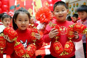 Children Learning Folk Customs to Welcome Chinese Lunar New Year