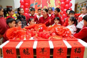 Children Learning Folk Customs to Welcome Chinese Lunar New Year