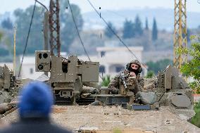 Israeli Soldiers Gather Behind Rubble In A Southern Lebanese Village