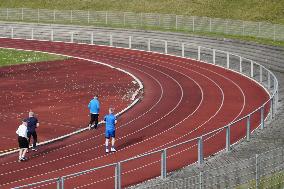 Seniors Jogging On An Outdoor Sports Field In Munich