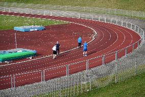 Seniors Jogging On An Outdoor Sports Field In Munich