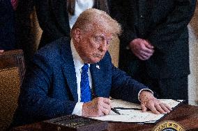 US President Donald Trump signs the Laken Riley Act