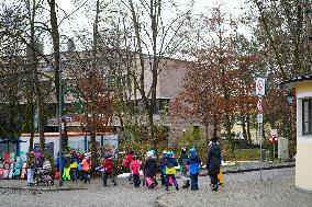 Teachers Leading Children Safely Through The Streets