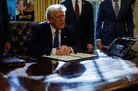 DC: U.S. President Trump Signs Executive Orders in the Oval Office