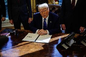 DC: U.S. President Trump Signs Executive Orders in the Oval Office