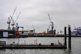 Freight Cranes In The Harbor Of Hamburg