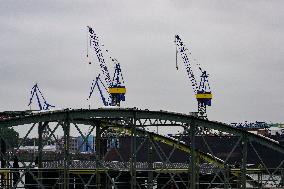 Freight Cranes In The Harbor Of Hamburg