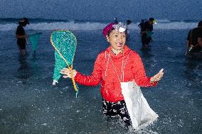 The Sasak People Gather To Catch Sea Worms Or Bau Nyale In Lombok, Indonesia.