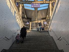 Travelers Ascend Stairs At A Railway Station