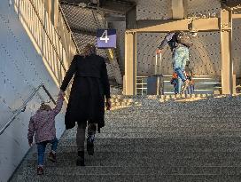 Travelers Ascend Stairs At A Railway Station