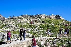 Tourists Visiting The Archaeological Site Of Mycenae.