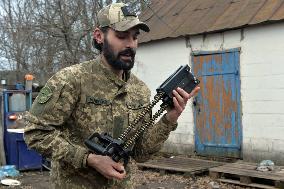 Serviceman of 57th Separate Motorized Brigade maintains American MK-19 grenade launcher