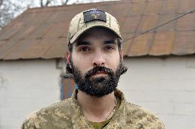 Serviceman of 57th Separate Motorized Brigade maintains American MK-19 grenade launcher