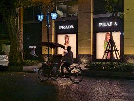 Cyclo Passing By Prada Store In Hanoi