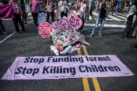 Pro-Palestinian protestors march from the National Gallery to ICE Headquarters in Washington, DC, on Saturday April 5, 2025. Thi