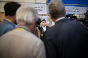 Macron talks to the media during a visit at Egyptian Red Crescent - Egypt