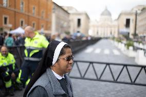 People queue at St Peter Basilica to pay their respects to late Pope Francis - Rome