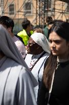 People queue at St Peter Basilica to pay their respects to late Pope Francis - Rome