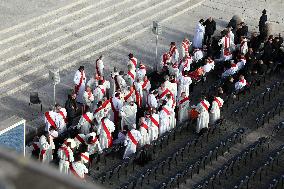 The faithful and priests wait on the steps of St Peter s Basilica for the Funeral of Pope Francis