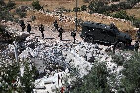 Israeli excavators demolish the houses in Hebron