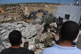Israeli excavators demolish the houses in Hebron