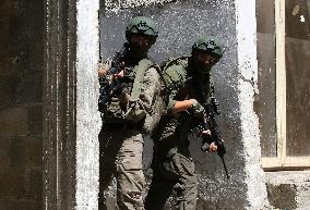 Israeli excavators demolish the houses in Hebron