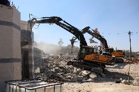 Israeli excavators demolish the houses in Hebron