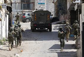 Israeli excavators demolish the houses in Hebron