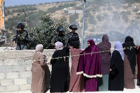 Israeli excavators demolish the houses in Hebron