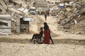 Palestinians Walking In A Sandstorm - Gaza