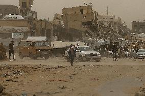 Palestinians Walking In A Sandstorm - Gaza