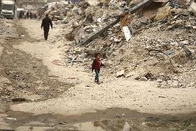 Palestinians Walking In A Sandstorm - Gaza
