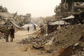 Palestinians Walking In A Sandstorm - Gaza