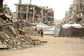 Palestinians Walking In A Sandstorm - Gaza