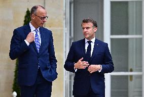 Macron and Merz Discuss in Elysee Garden - Paris