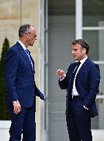 Macron and Merz Discuss in Elysee Garden - Paris