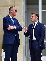 Macron and Merz Discuss in Elysee Garden - Paris