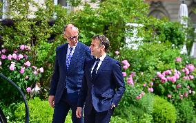 Macron and Merz Discuss in Elysee Garden - Paris