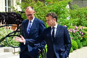 Macron and Merz Discuss in Elysee Garden - Paris