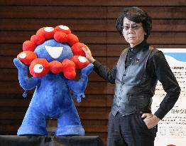 Roboticist Ishiguro with expo mascot