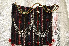 Collection of old Bulgarian towels, clothes and jewelry in Krynychne village