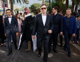 Cannes Raphael Quenard, Francois Civil, Michel Hazanavicius walk with condor from Hotel Martinez MP